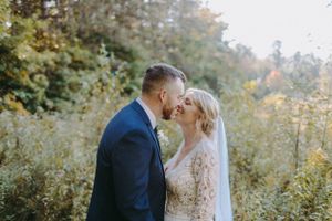 Romantic outdoor wedding portraits in autumn natural setting with golden light.