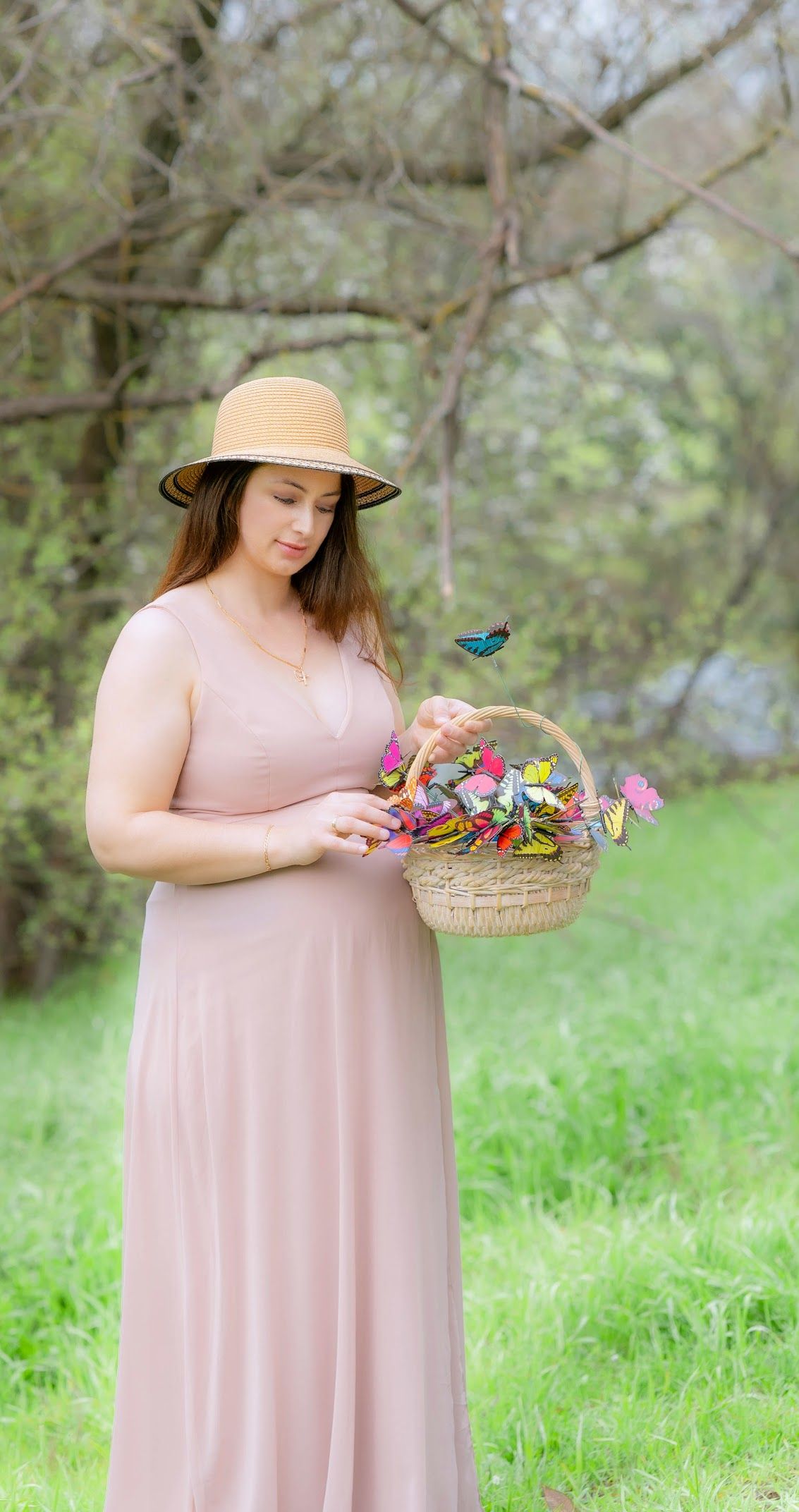 This image captures the beauty and joy of pregnancy in a natural, dreamy setting.