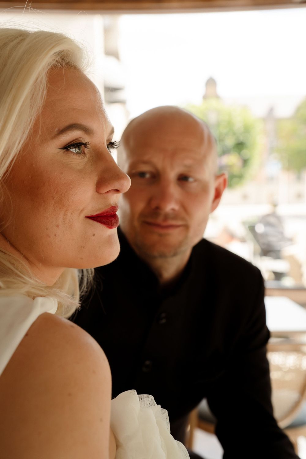 Intimate wedding portrait showing stylish couple in warm lighting.