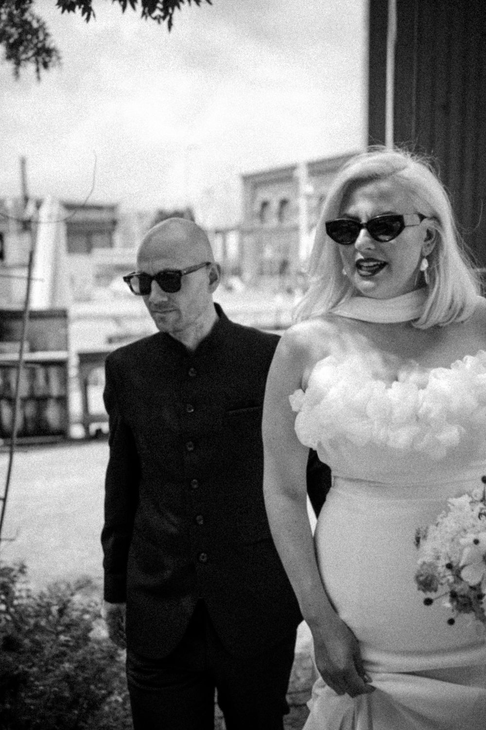 Black and white stylized wedding portrait with vintage aesthetic.