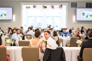 Young guest enjoying celebration at wedding reception in banquet hall.