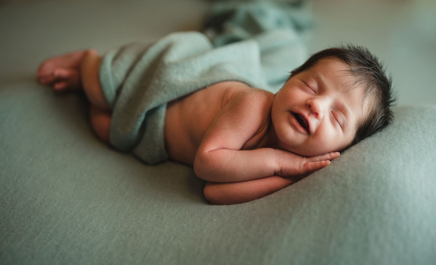 Lakeland Newborn Photographer- newborn girl swaddled in green