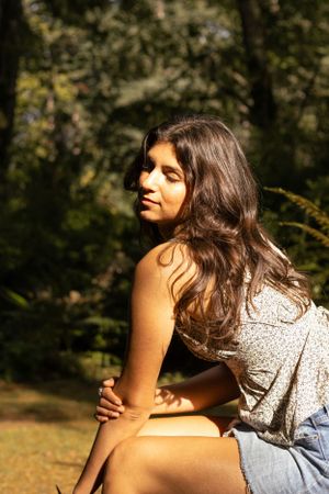 Cora Emilie Media Casual outdoor portrait session with natural sunlight filtering through trees.