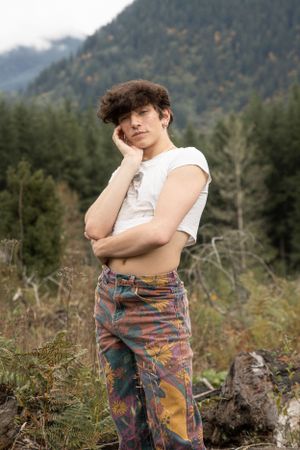 Cora Emilie Media A casual outdoor portrait with mountains and forest in the background.