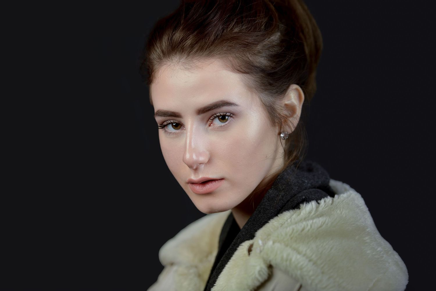 Portrait of a woman with beautiful skin, makeup and illuminated by studio lighting