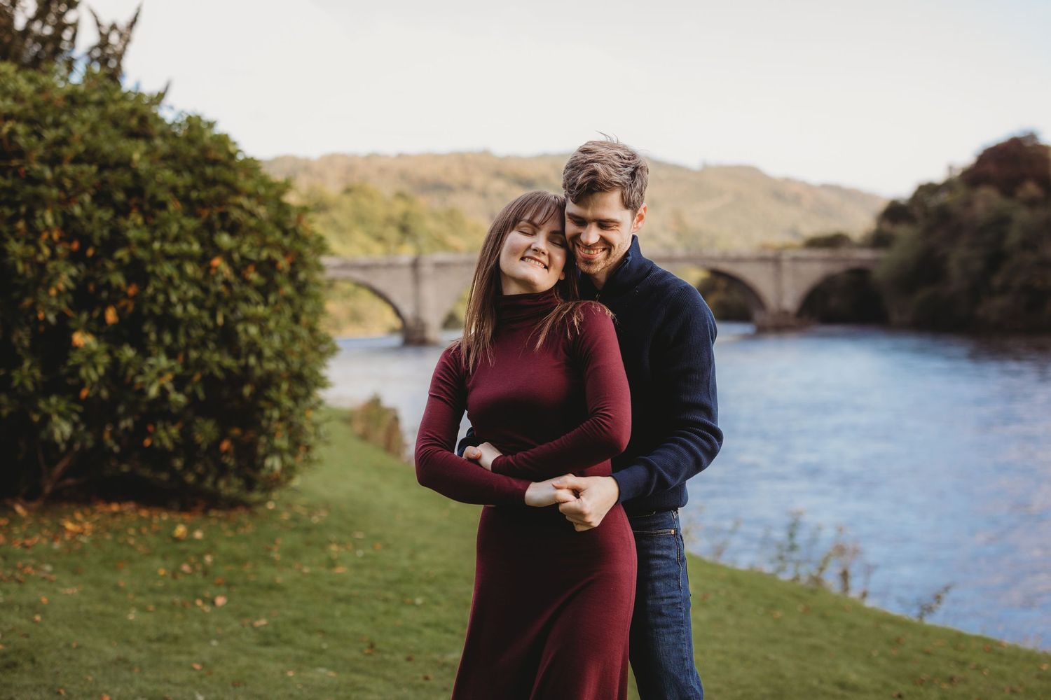 Intimate outdoor portrait of couple embracing in autumn setting.