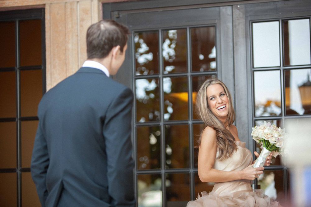Bride and groom share intimate moment during their wedding portrait session at sunset.