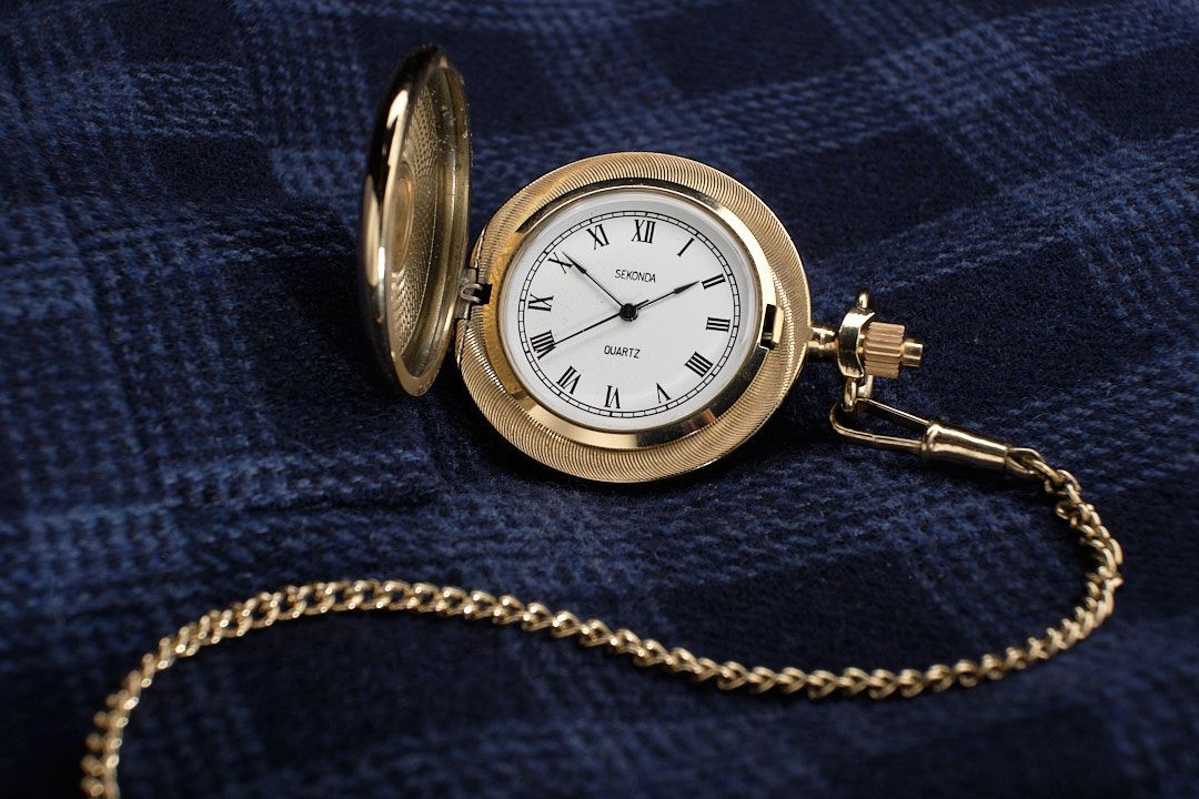 Sekonda gold coloured pocket watch on a blue cheque Cotton Traders waistecoat.