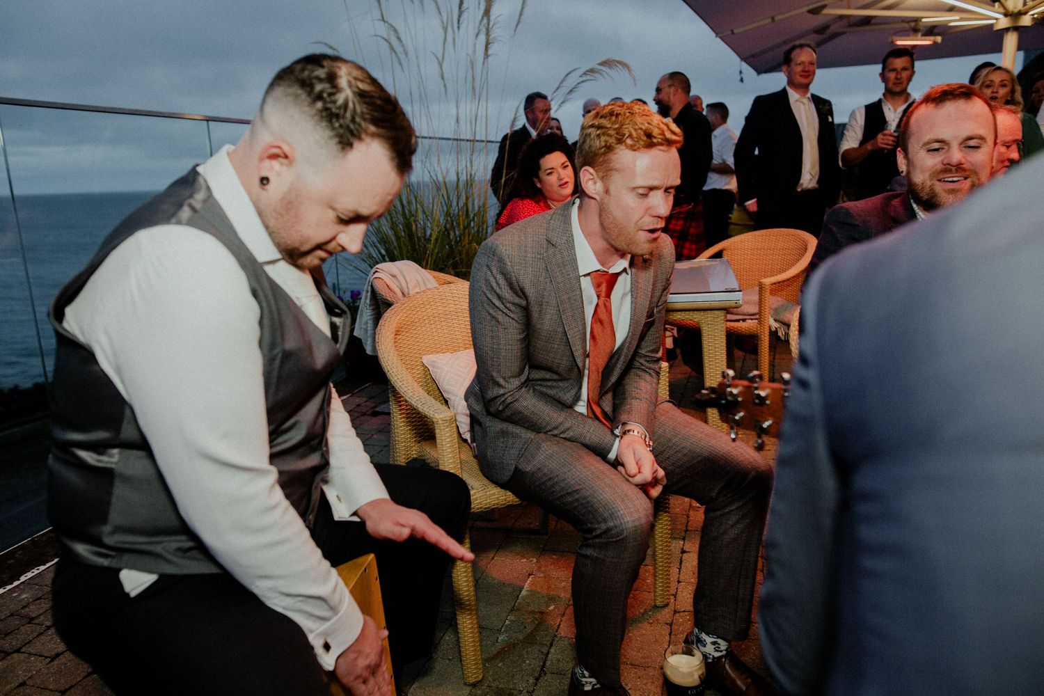 Wedding guests enjoying a lively moment during an outdoor reception celebration.