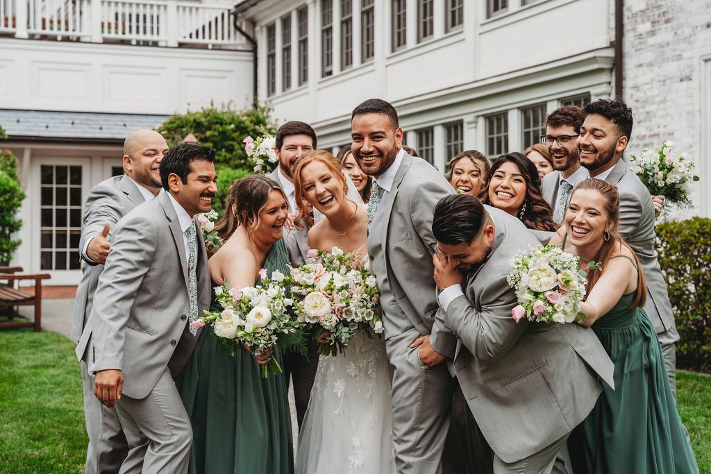 wedding party group hug photo at the inn on boltwood in massachusetts