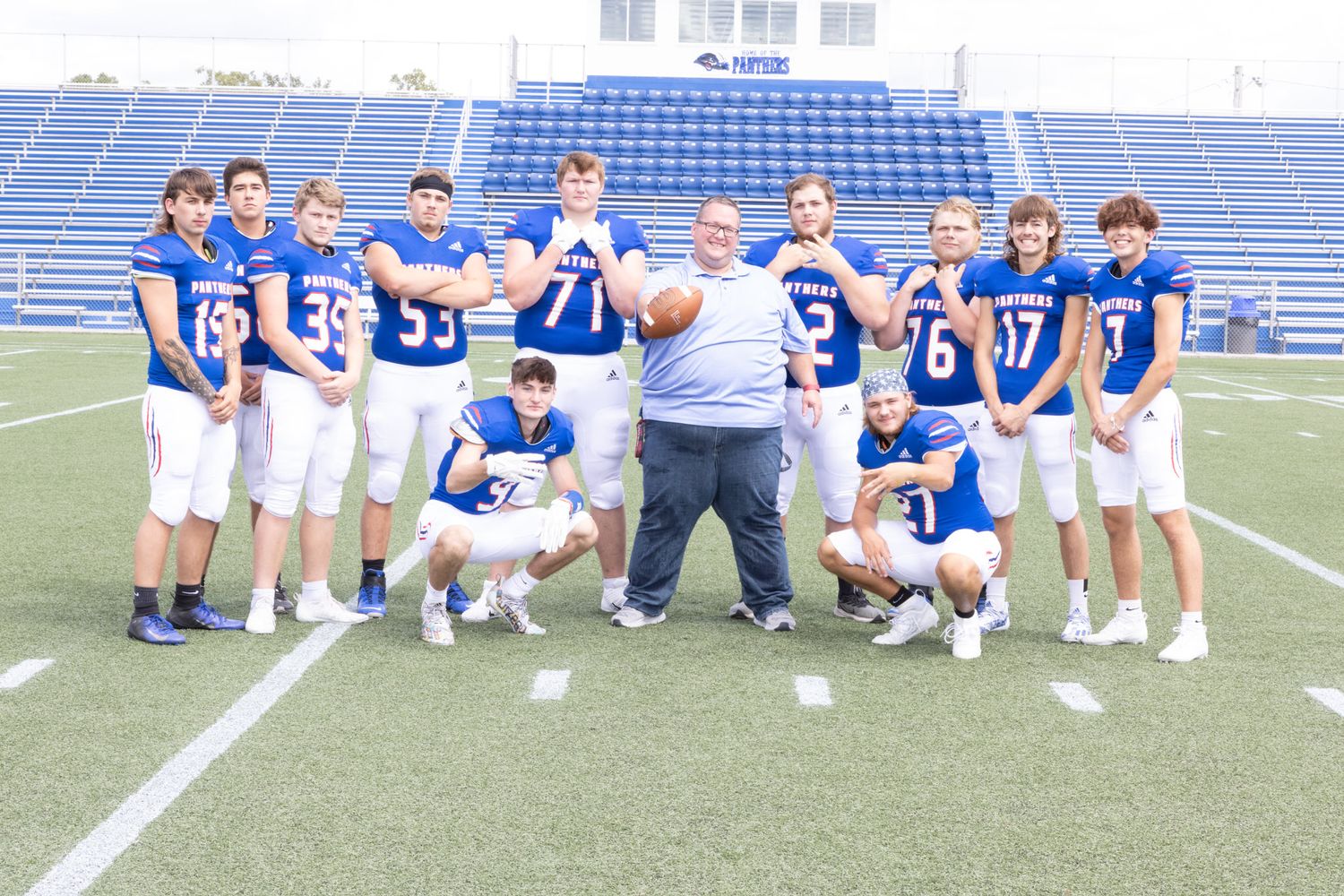 football team around photographer