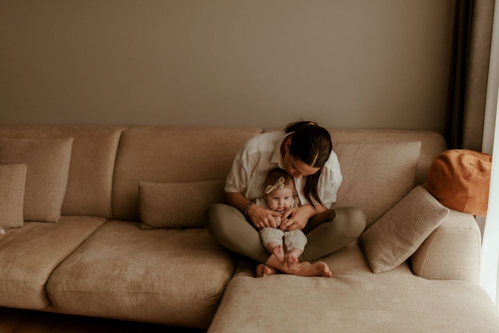 Lifestyle family photography with soft neutral tones and natural poses.