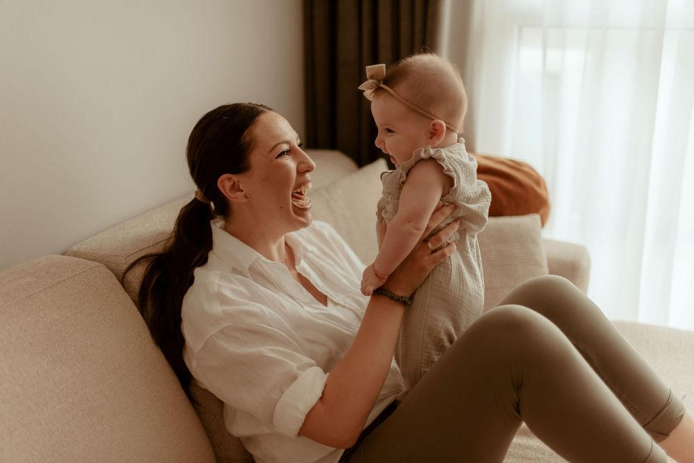 Joyful family bonding moment captured in natural light by a window.