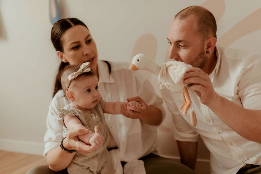 Candid family moments captured in a minimalist indoor setting.