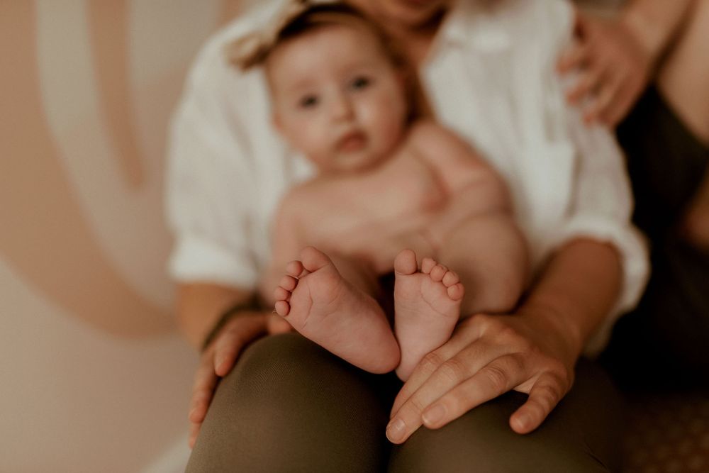 Close-up lifestyle photography of baby's tiny feet and hands.