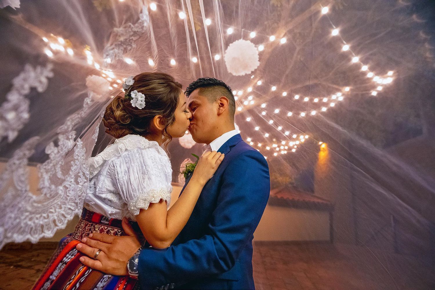 A romantic wedding dance scene under twinkling string lights creating a magical evening atmosphere.