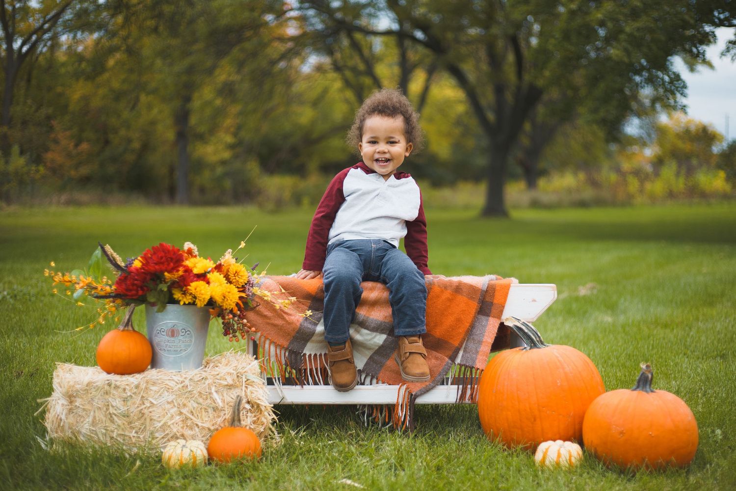 smiling toddler pumpkins fall photoshoot outdoors odana hills park