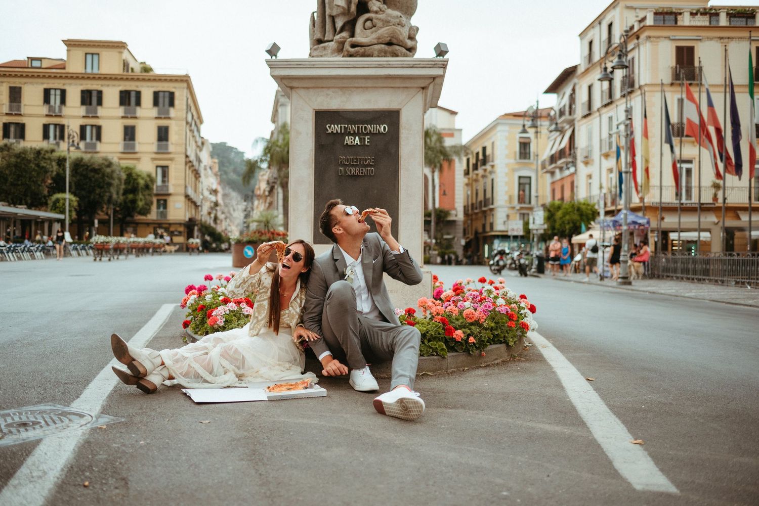 European town square with historic buildings and flower decorations.