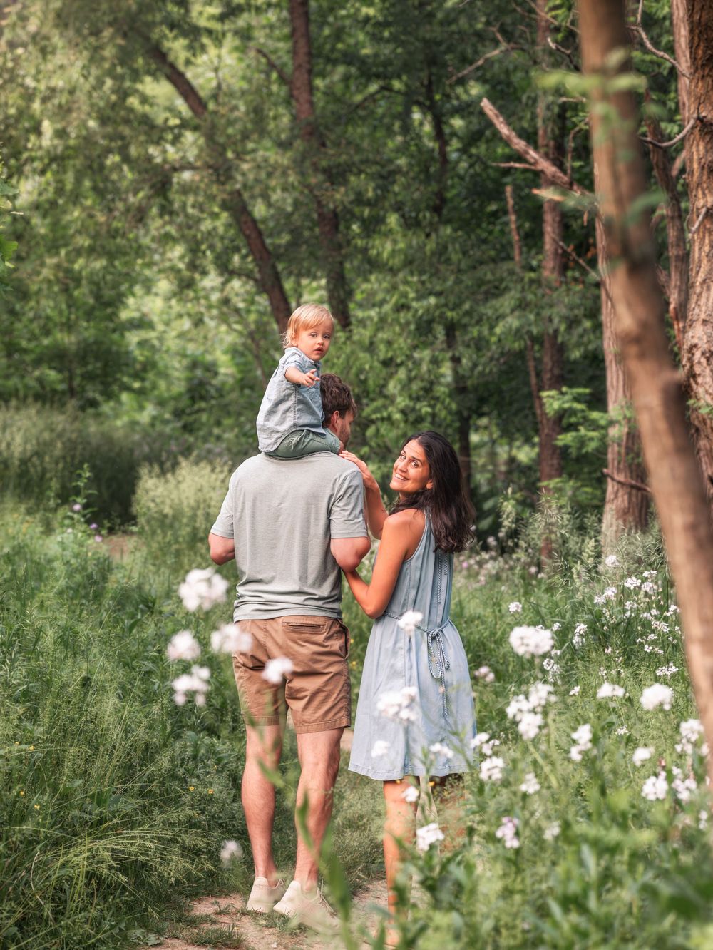 Outdoor family photo in magical wooded path and flowers