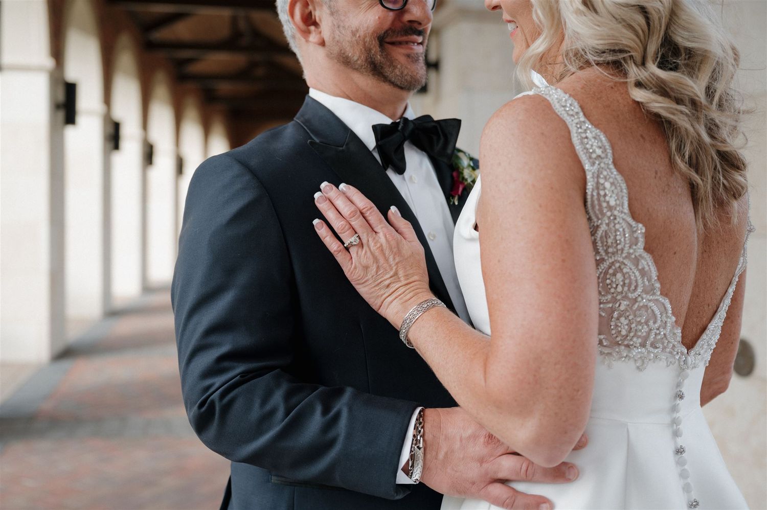Close-up of couple sharing tender moment in formal wedding attire.