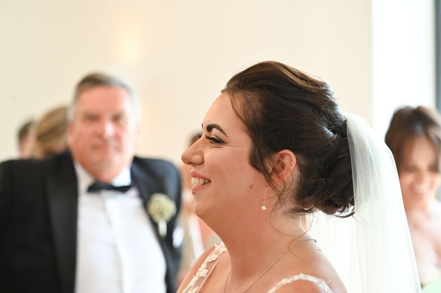A joyful candid moment during a formal wedding celebration.