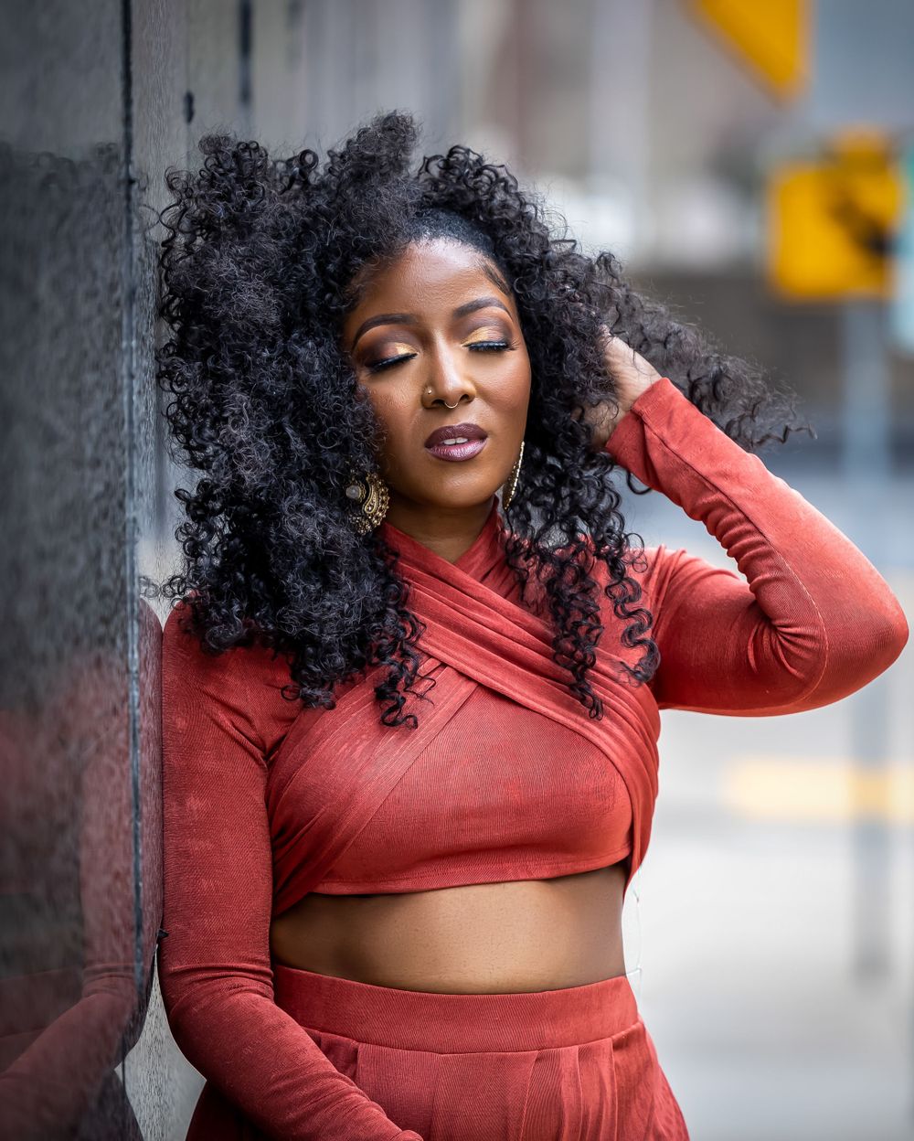 Fashionable coral crop top and pants set showcased in urban street setting.