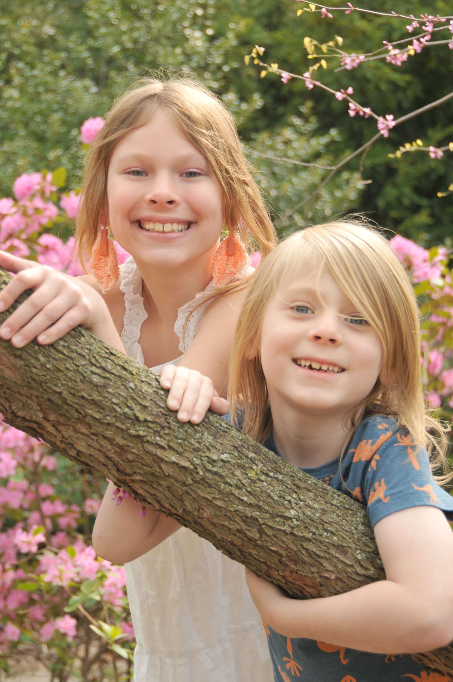 Two young siblings outside in springtime photo