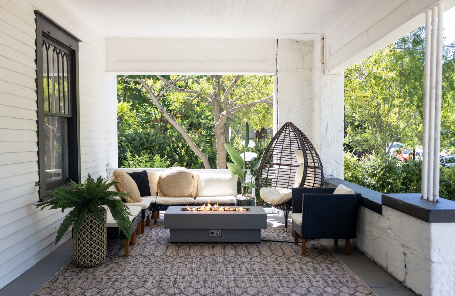 Inviting front porch with comfortable outdoor furniture arranged for relaxation.