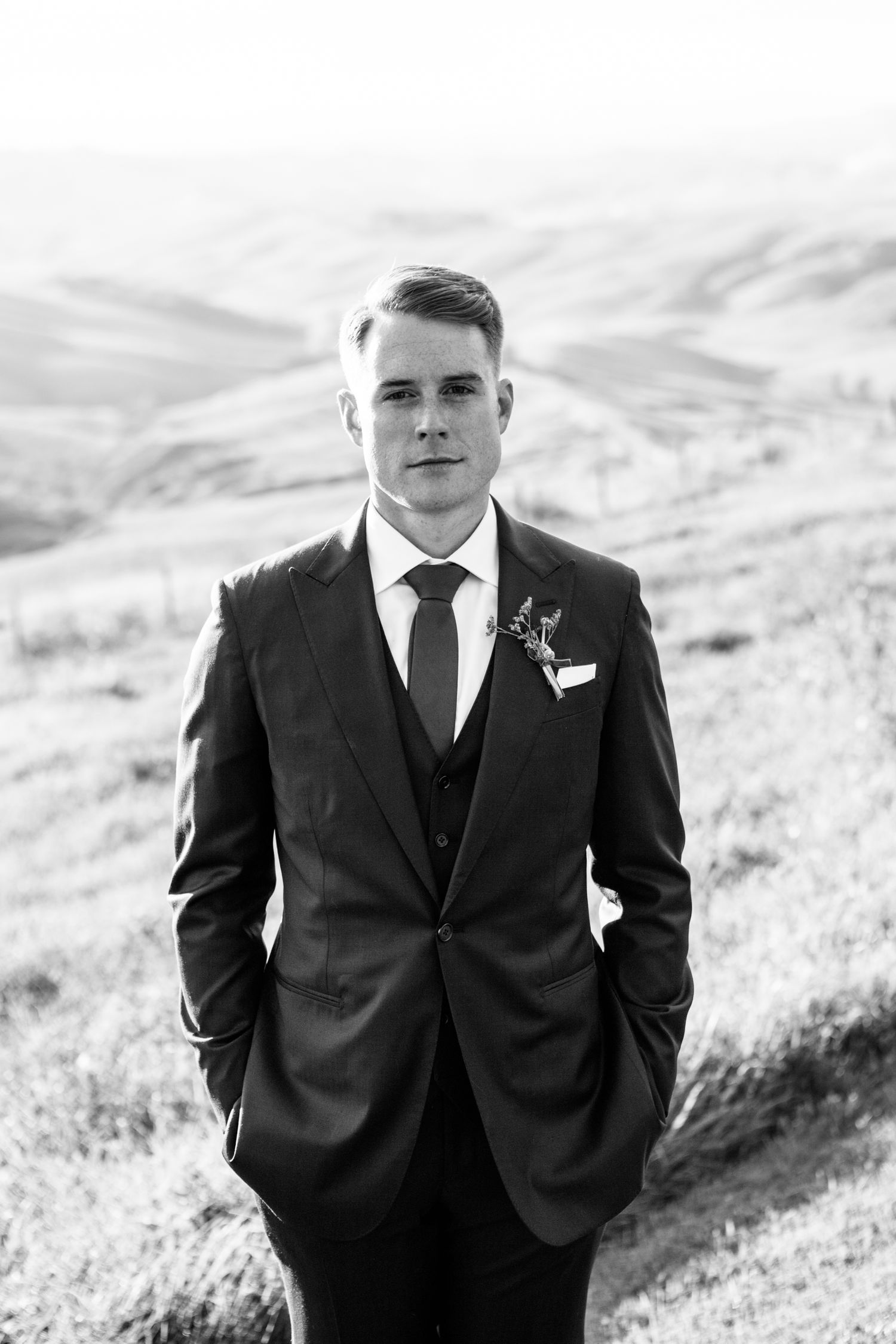Modern black and white portrait photography of a groom at a wedding in Tuscany.