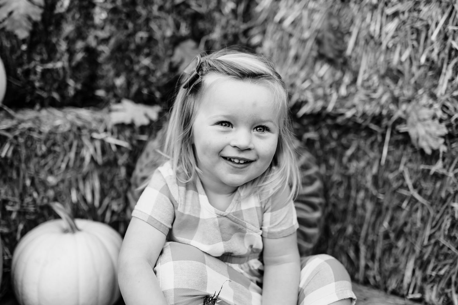 Candid black and white outdoor portraits in a garden setting with natural light.