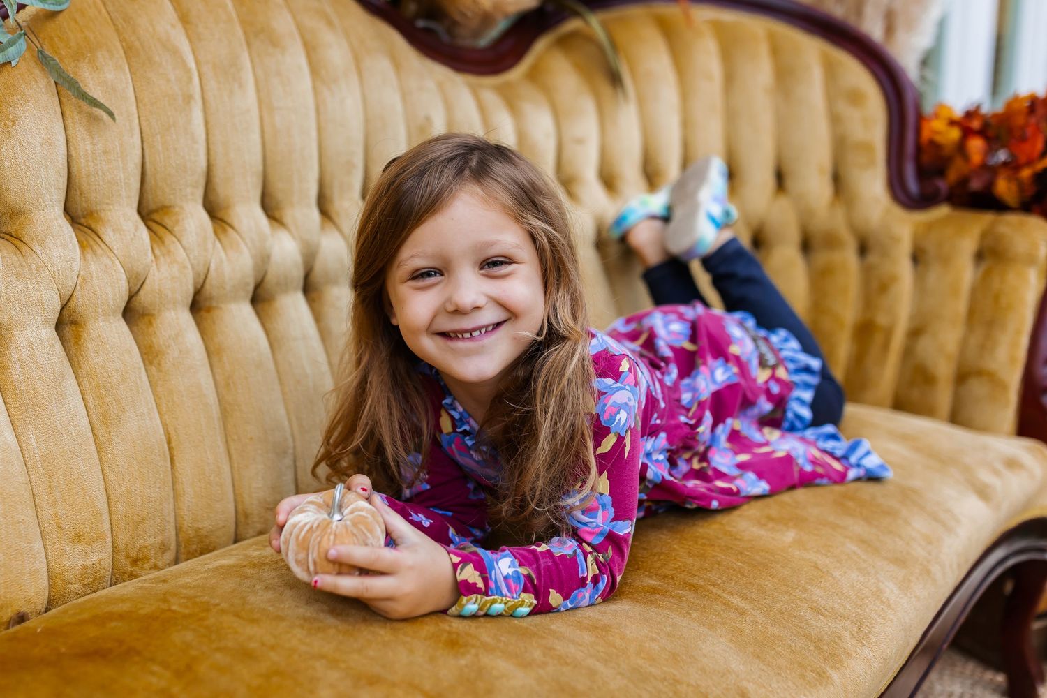 Cozy autumn portrait session on vintage gold velvet couch.