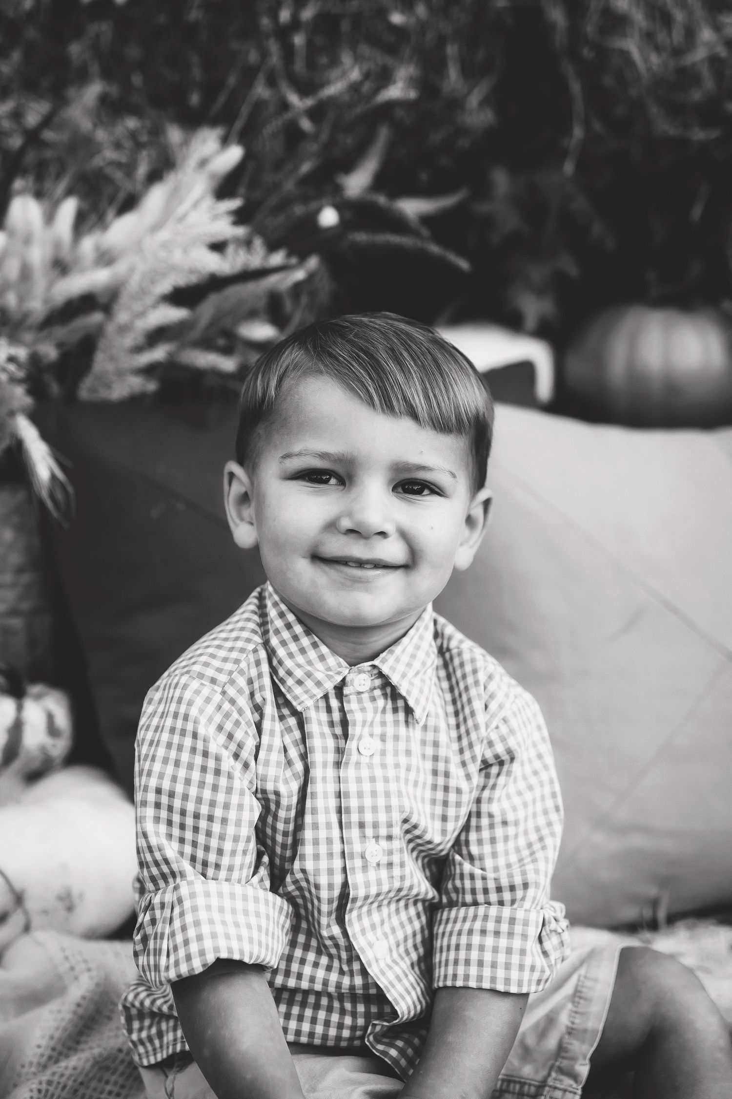 Black and white portrait series showing expressions in checkered shirt.