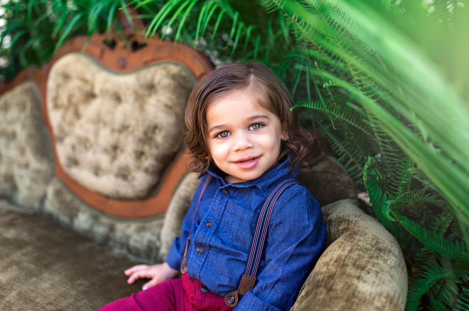 Series of outdoor portraits taken against lush green palm plants and stone wall background.