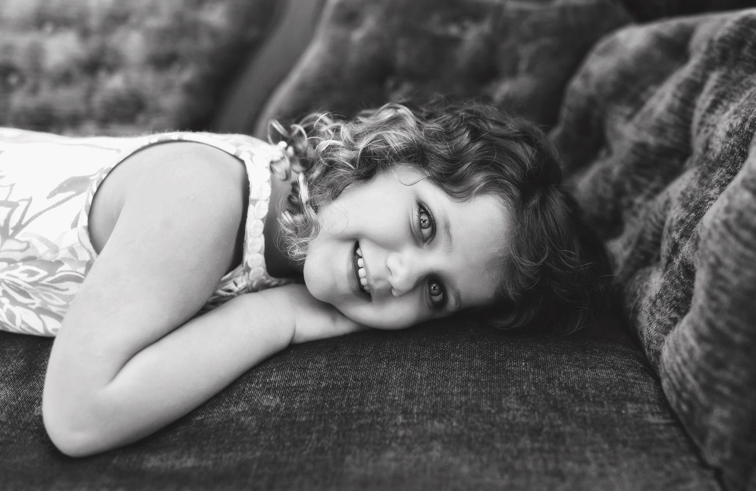 Artistic black and white portraits on textured antique furniture.