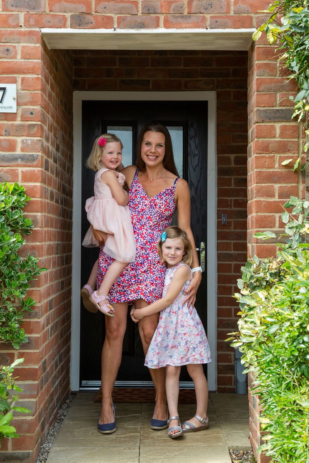 A mum and her daughters doorstep portrait