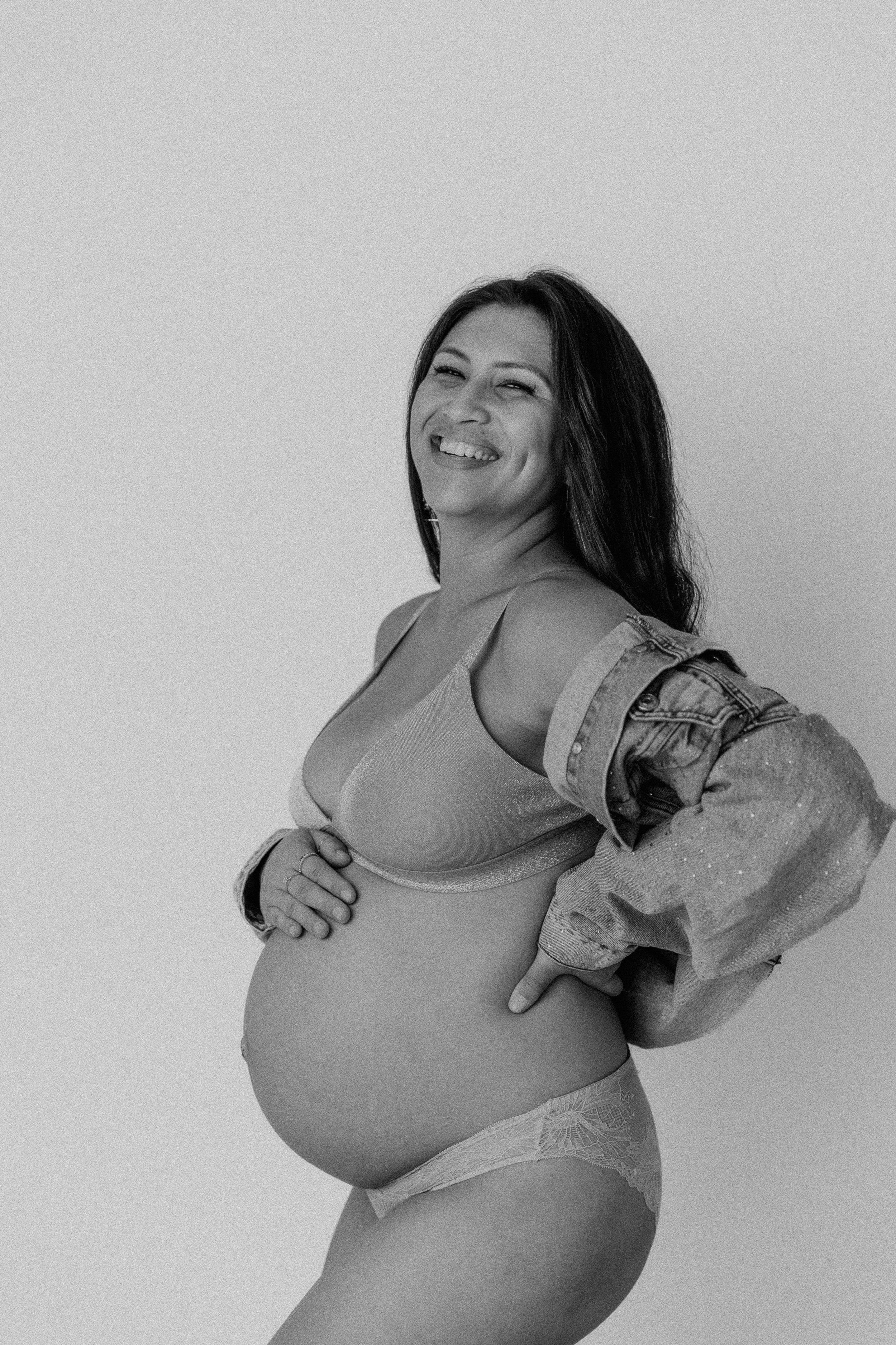 Black and white maternity portraits showing joyful moments and natural expressions.