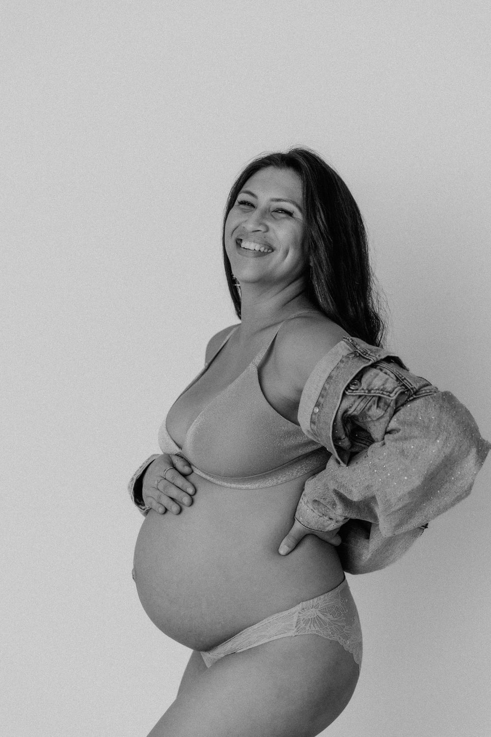 Black and white maternity portraits showing joyful moments and natural expressions.