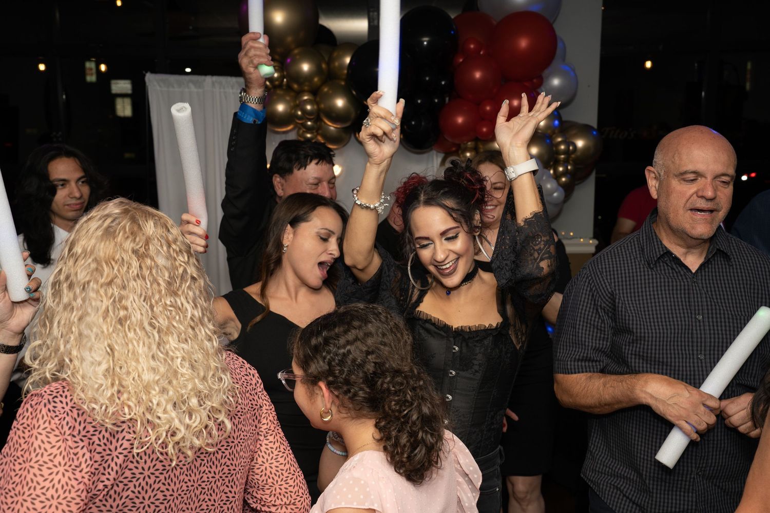 Candid shots of guests enjoying themselves at evening celebration.