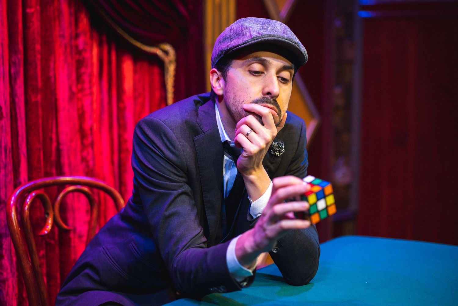 Magician Siegfried Tieber examines a Rubik's cube. Photo by Amy Hanoa.