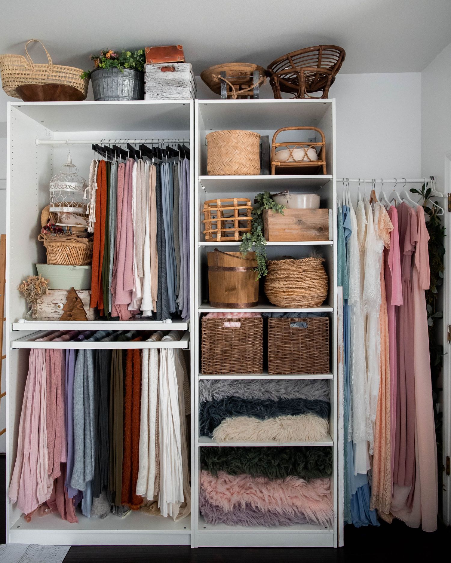 Well-organized closet with pink dresses, wicker baskets, and built-in white shelving.