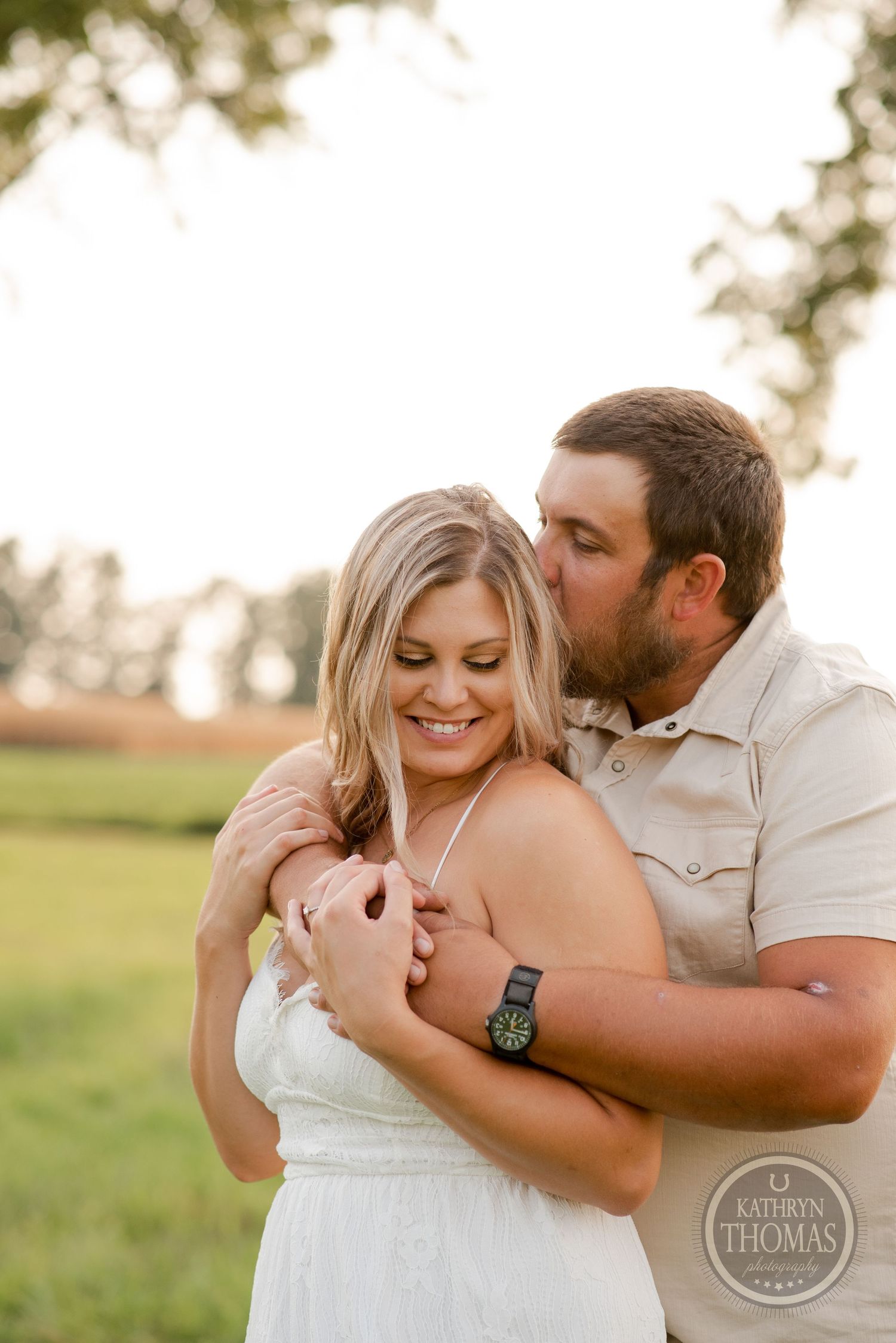 An intimate moment shared between a couple during a golden hour photoshoot.