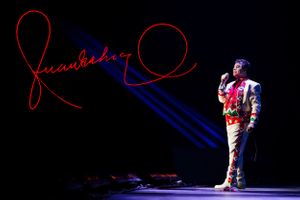 Stage performance with red lighting effects and artistic silhouettes.