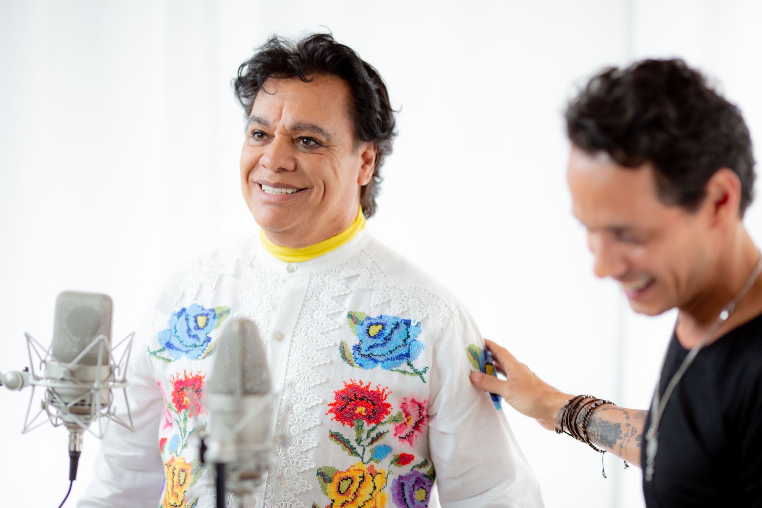 Artists and musicians collaborate in a creative studio session with various instruments and equipment.