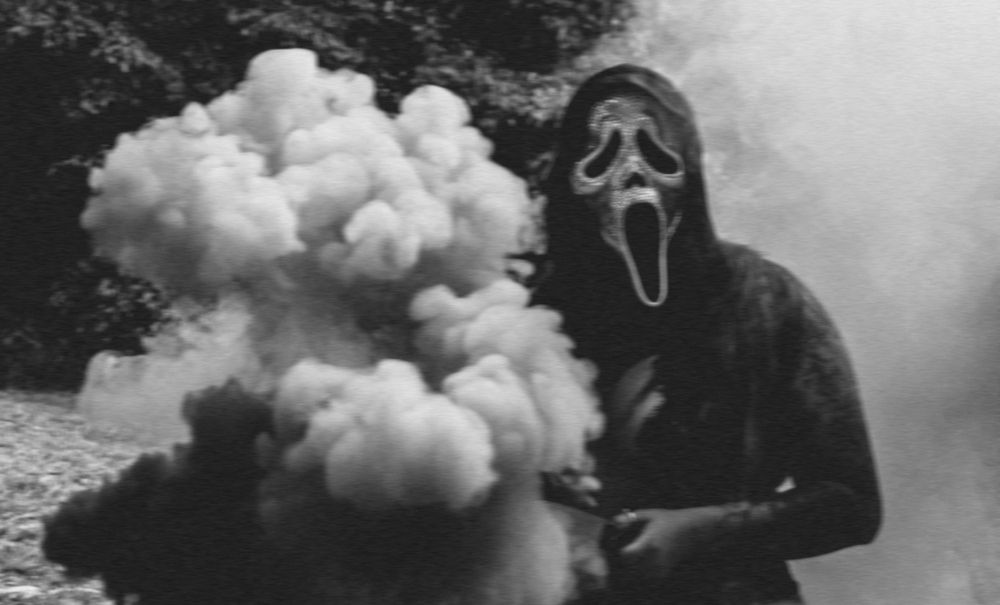 Dramatic black and white photo with white smoke effects in a natural setting.
