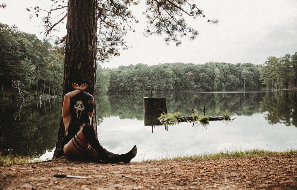 Scenic lakeside photo session with natural lighting and forest backdrop.