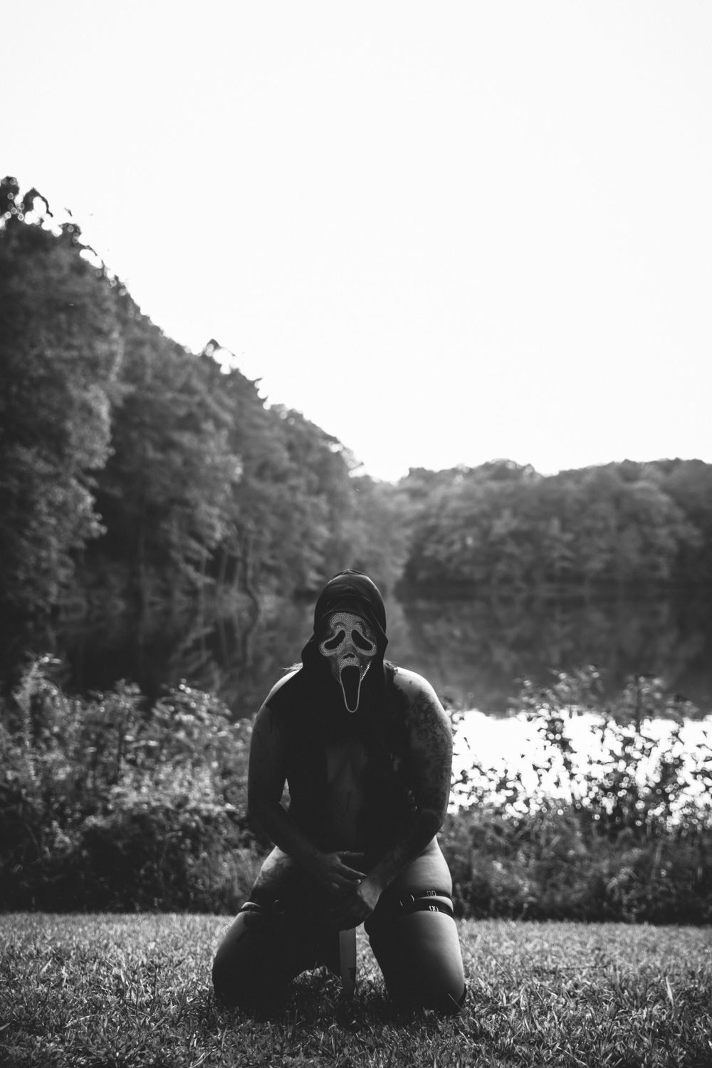 Minimalist black and white landscape photography with silhouette by lake.