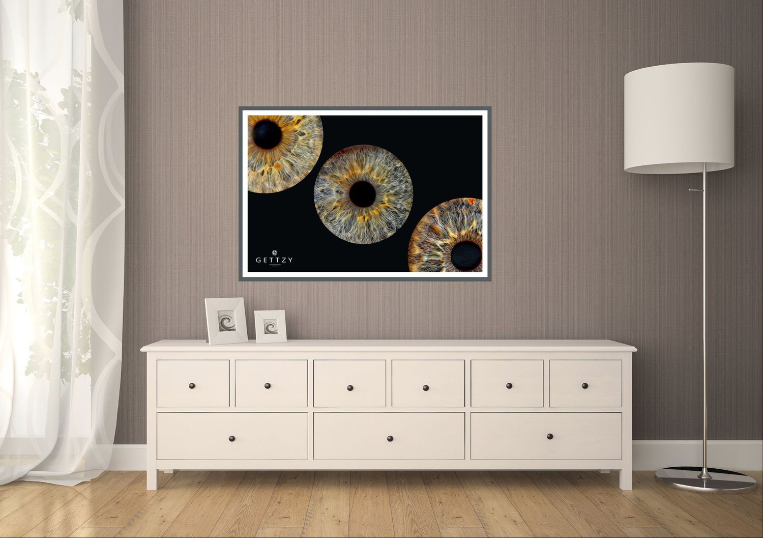 Wall art featuring iris patterns displayed above white dresser in modern room.