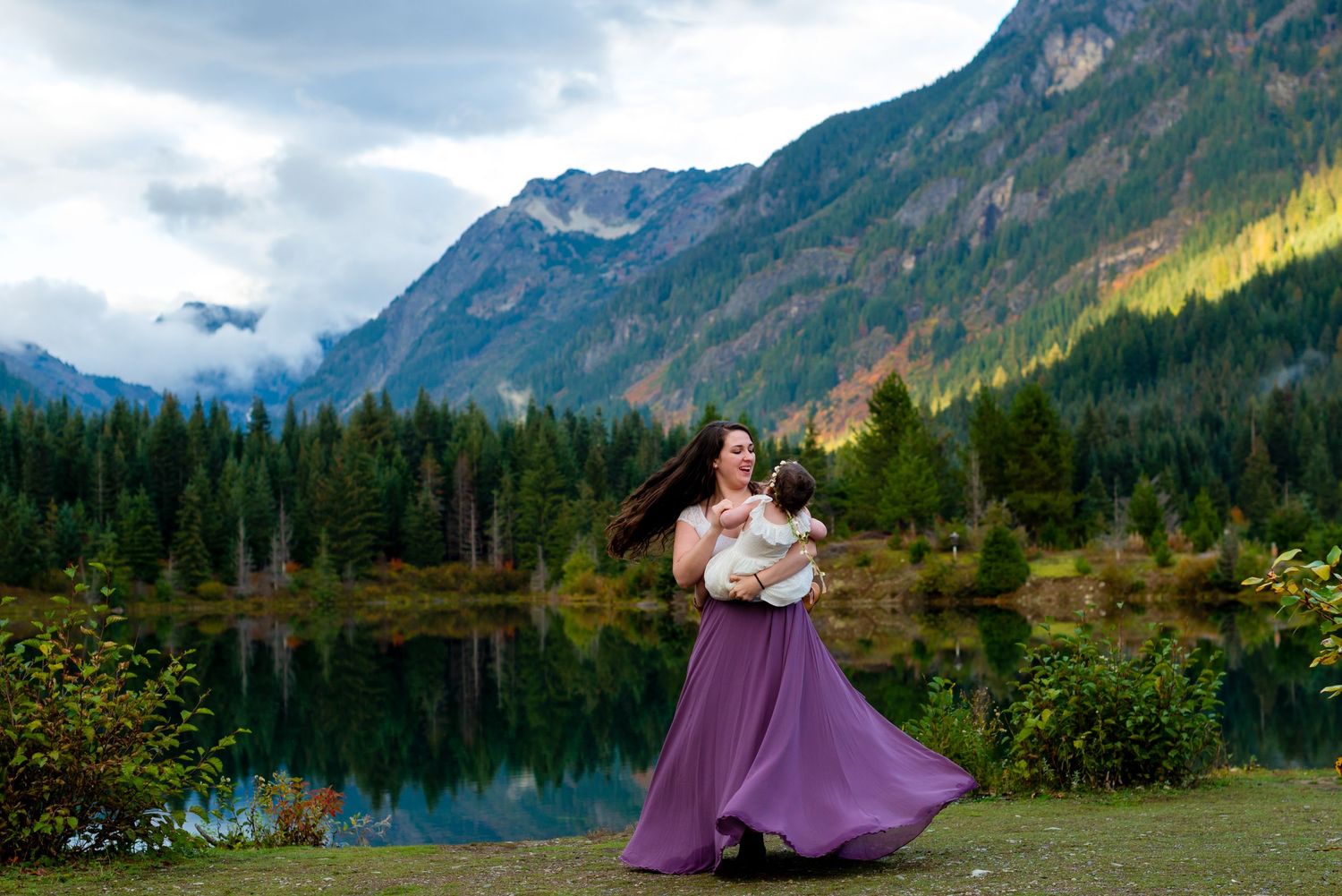 Scenic mountain lake engagement session with dramatic peaks and reflections.