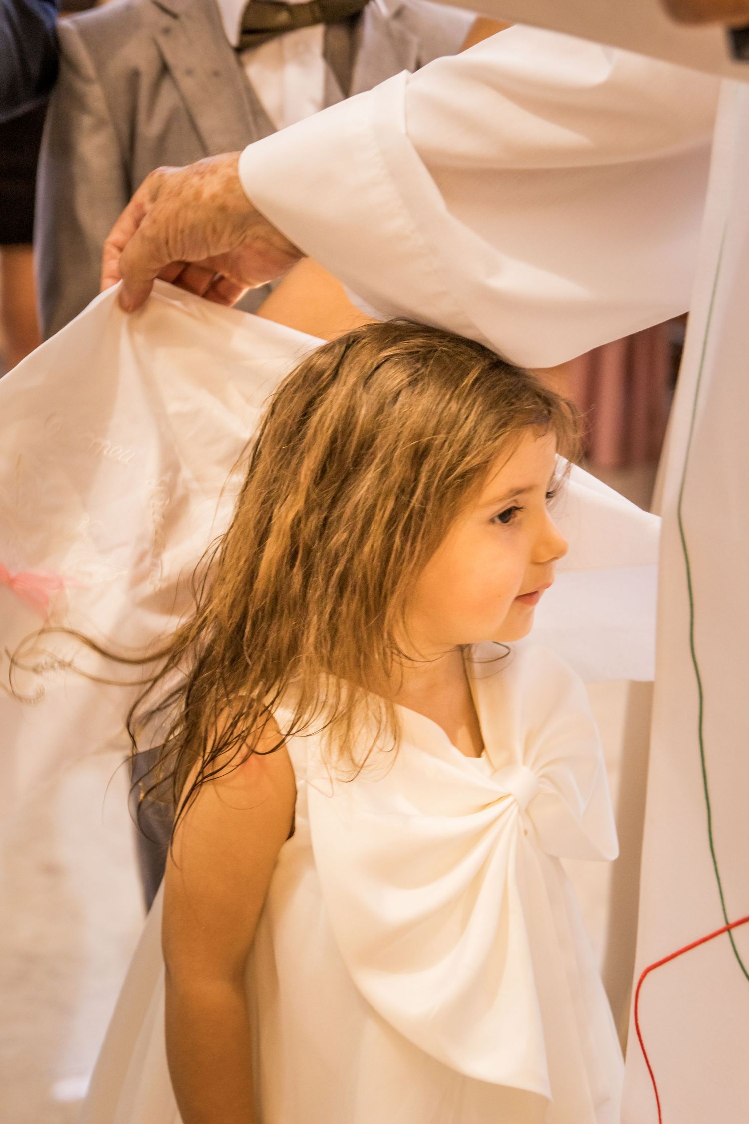 A sequence showing someone in a white dress getting their hair styled.