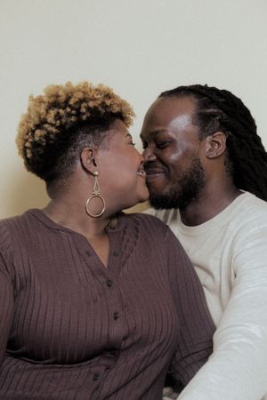 Romantic sequence of couple sharing intimate moments against neutral background.
